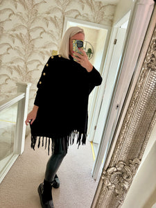 The tassel poncho style jumper with gold button detailing