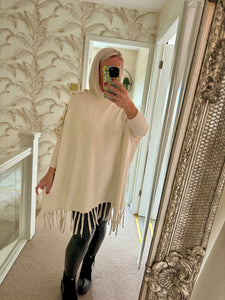 The tassel poncho style jumper with gold button detailing