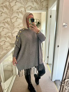 The tassel poncho style jumper with gold button detailing